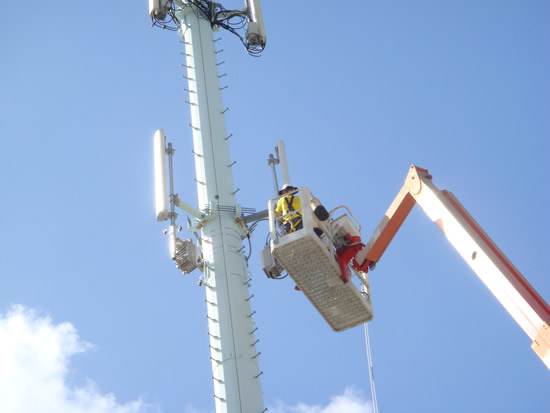 Agat Cell Site Mono-Pole with Riggers Installing Antenna